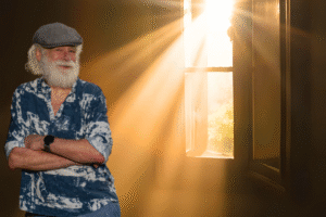 Paul P standing in front of a window with light filtering in